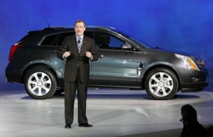 The 2010 Cadillac SRX -- shown here at its preview with GM executive Troy Clarke -- will be going up against the luxury crossover leader, the newly-updated 2010 Lexus RX350.