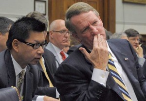 GM CFO Ray Young huddles with former Chairman Rick Wagoner during a Washington hearing called to discuss the automaker's request for a federal bailout.