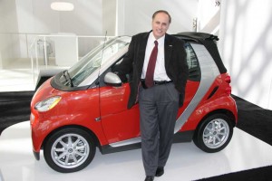 Could an extra pair of doors and a back seat expand the appeal of Smart's cars, the fortwo model shown here with CEO Dave Schembri?