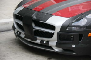 Some tape and a couple frames attempt to mislead the eye when it comes to the front end design of the 2011 Mercedes SLS, but the German maker's big tri-star badge on the grille is still quite obvious.