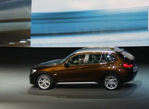 The 2010 BMW X1 circles the stage at the automaker's stand.