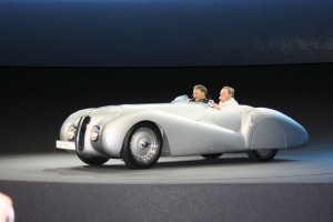 BMW CEO Norbert Reithofer circles the test track at the automaker's Frankfurt Motor Show stand in a classic Bavarian roadster.